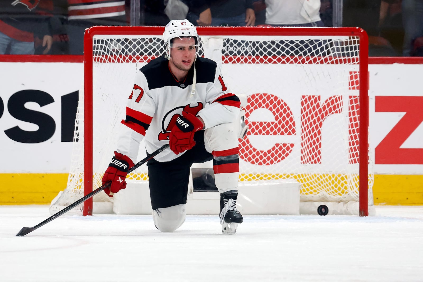 New Jersey Devils' Simon Nemec (17) watches the Carolina Hurricanes celebrate Sebastian Aho's game winning overtime goal during the second overtime period of Game 5 of an NHL hockey Stanley Cup first-round playoff series in Raleigh, N.C., Tuesday, April 29, 2025. (AP Photo/Karl DeBlaker)