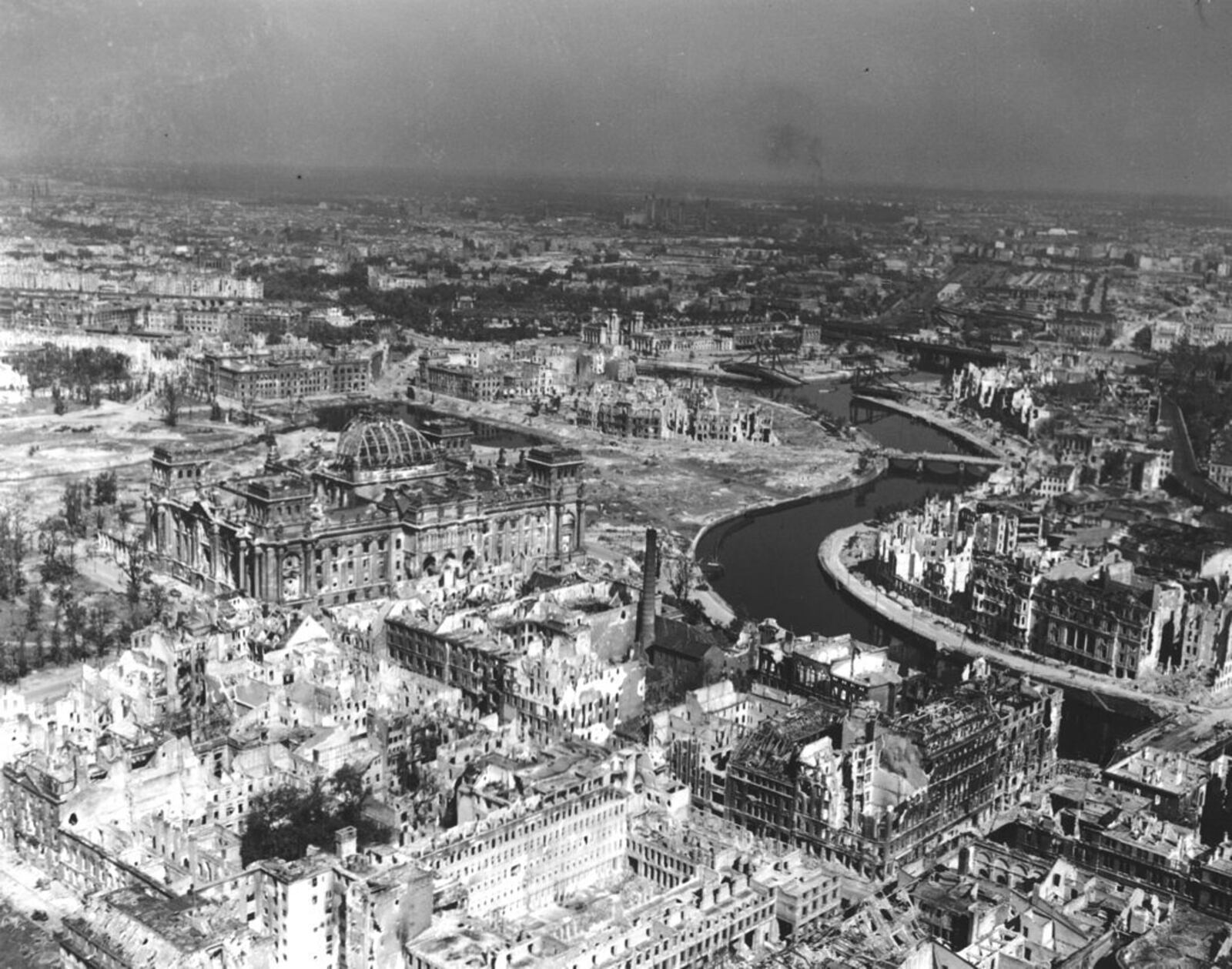 FILE - A view taken from a Cub artillery observation plane on July 10, 1945, shows vast areas of destruction in Berlin, after repeated Anglo-American air raids on the German capital. Seen on the left, center, is the heavily damaged building of the German Reichstag with its distinct cupola, in the background center are the remains of Lehrter Bahnhof, one of the city's train stations. (AP Photo, File)