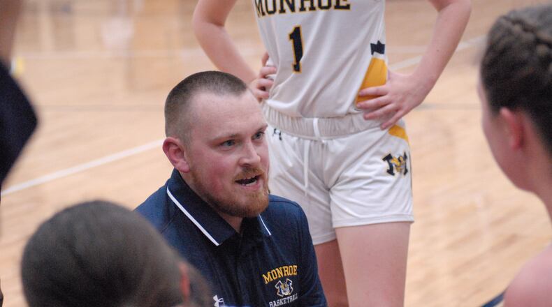 Monroe coach Justin Clemmons talks to his players during a timeout against Hamilton on Tuesday night. Chris Vogt/CONTRIBUTED