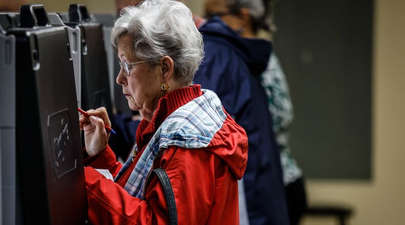 Early voter, Judy Marin from Clayton, casts her vote at the Montgomery County Board of Elections Monday October 31, 2022. JIM NOELKER/STAFF