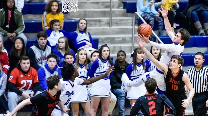 Hamilton’s Kurtis Reid jumps for a rebound over Lakota West’s Bradley Groth during their game Jan. 5, 2018, at the Hamilton Athletic Center. Host Big Blue won 60-34. NICK GRAHAM/STAFF