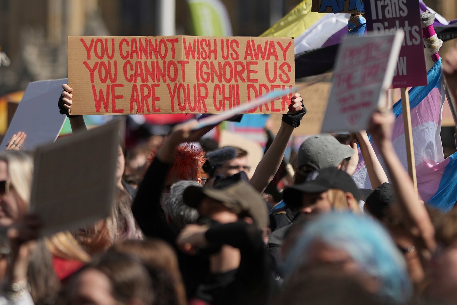 Campaigners take part in a rally organised by trans rights groups, trade unions, and community organisations following the Supreme Court ruling on the definition of a woman in equalities law, at Parliament Square, central London, Saturday April 19, 2025. (AP Photo/Alastair Grant)