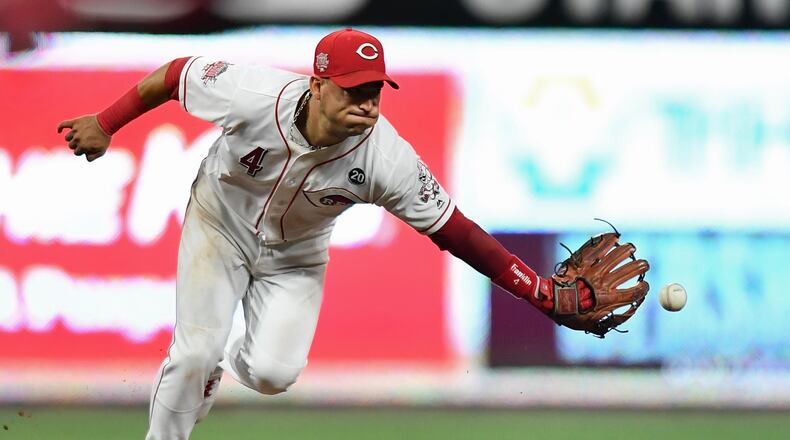 CINCINNATI, OH - JULY 19:  Jose Iglesias #4 of the Cincinnati Reds tosses the ball to second base after fielding a ground ball in the sixth inning against the St. Louis Cardinals at Great American Ball Park on July 19, 2019 in Cincinnati, Ohio. All runners were safe on the play.  (Photo by Jamie Sabau/Getty Images)