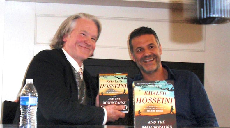 Vick Mickunas, left, with the novelist Khaled Hosseini at Books and Co. in Beavercreek. Hosseini is one of many authors Mickunas has interviewed on the journey to his 1,000th book column. CONTRIBUTED