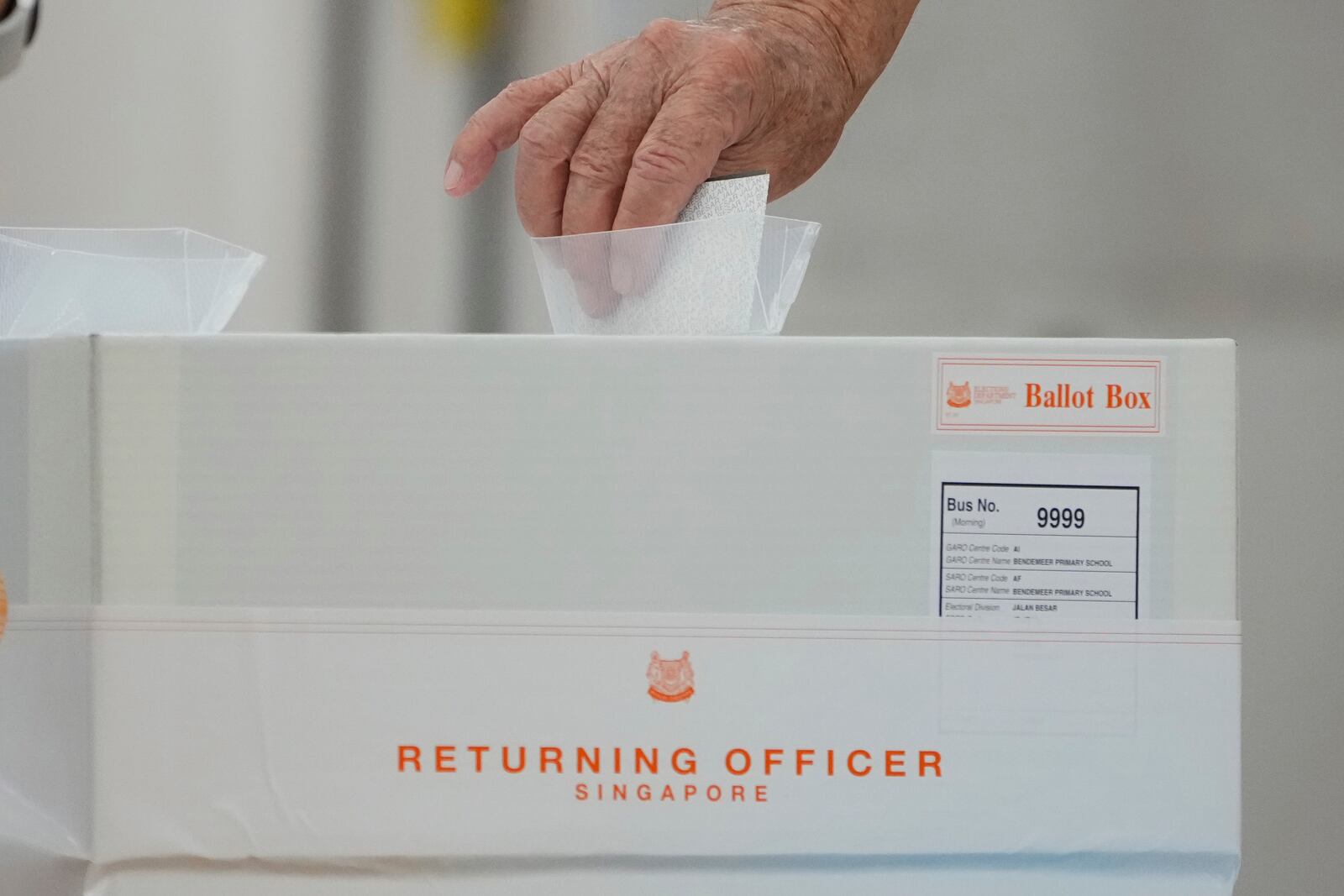 A Singaporean voter casts their vote for general election at polling station in Singapore, Saturday, May 3, 2025. (AP Photo/Vincent Thian)