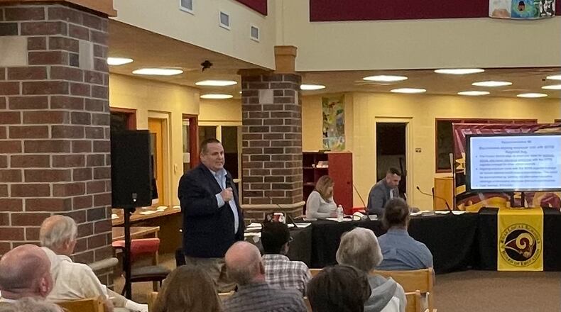 Budget cuts in personnel and programs are coming to Ross Schools regardless of the outcome of the May 2 tax hike issue but those reductions will be much worse, said district officials, if voters reject a levy for a third consecutive time in less than a year. Ross Schools Superintendent Chad Konkle (standing) told a school board work session audience Wednesday evening the Butler County district is in a "desperate" situation. (Photo By Michael D. Clark\Journal-News)