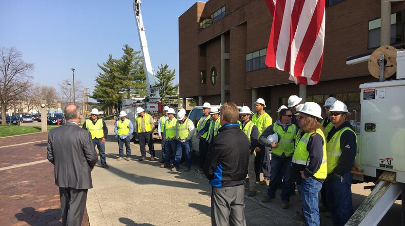 Middletown Mayor Larry Mulligan honors Duke Energy linemen with a proclamation on Wednesday, National Lineman Appreciation Day, outside the City Building. RICK McCRABB/STAFF