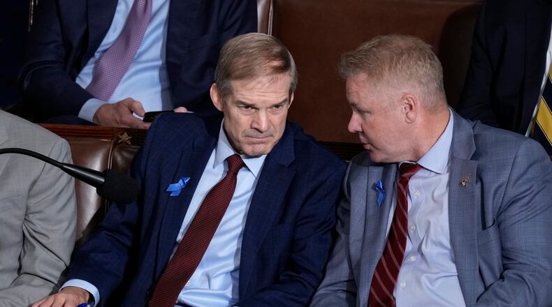 Rep. Jim Jordan, R-Ohio, right, confers with Rep. Warren Davidson, R-Ohio, right, as the House finishes voting on the second day of balloting to elect a speaker, at the Capitol in Washington, Wednesday, Oct. 18, 2023. (AP Photo/J. Scott Applewhite)