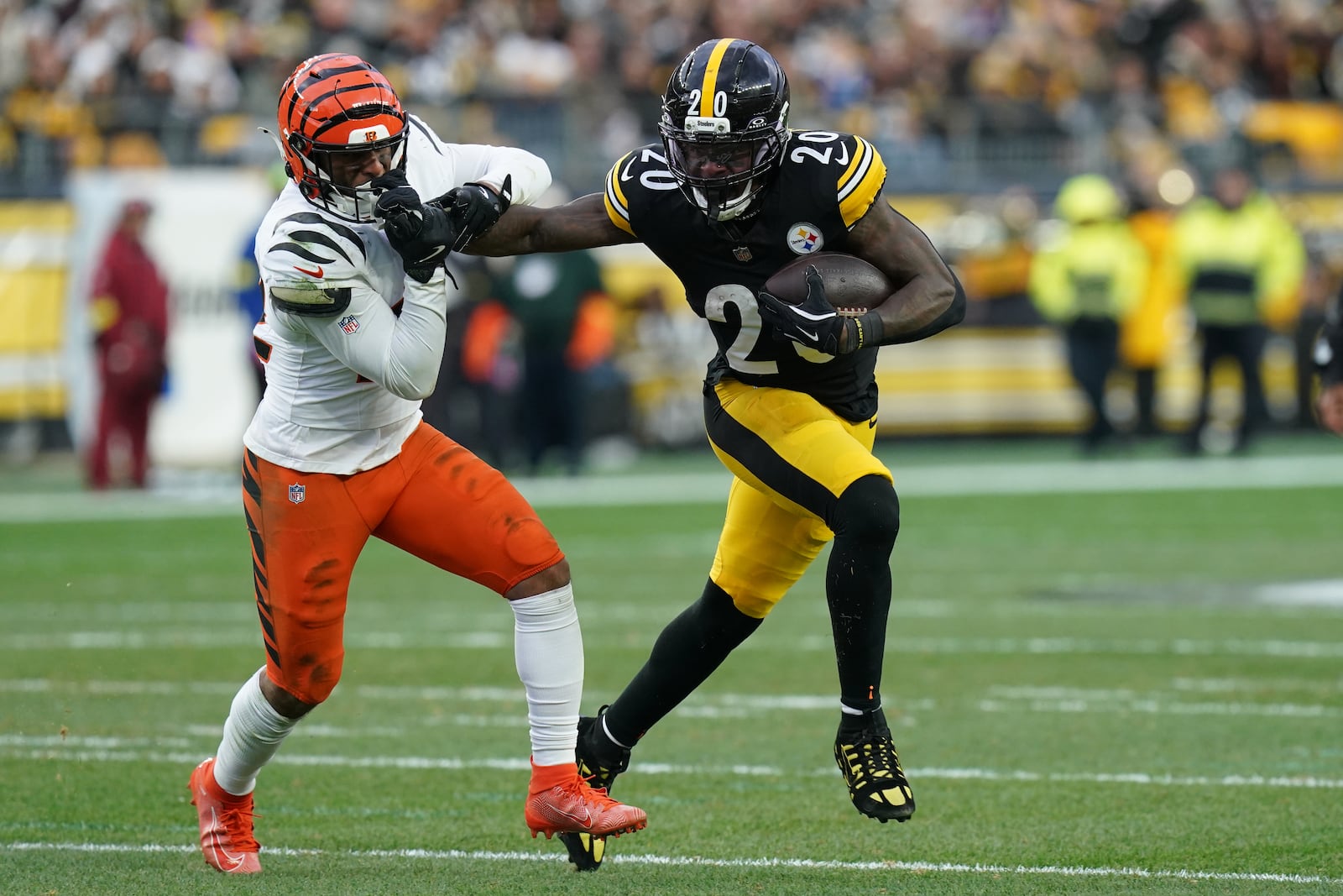 Pittsburgh Steelers running back Kaleb Johnson (20) facemasks Cincinnati Bengals safety Geno Stone (22) during the second half of an NFL football game Sunday, Nov. 16, 2025, in Pittsburgh. (AP Photo/Matt Freed)