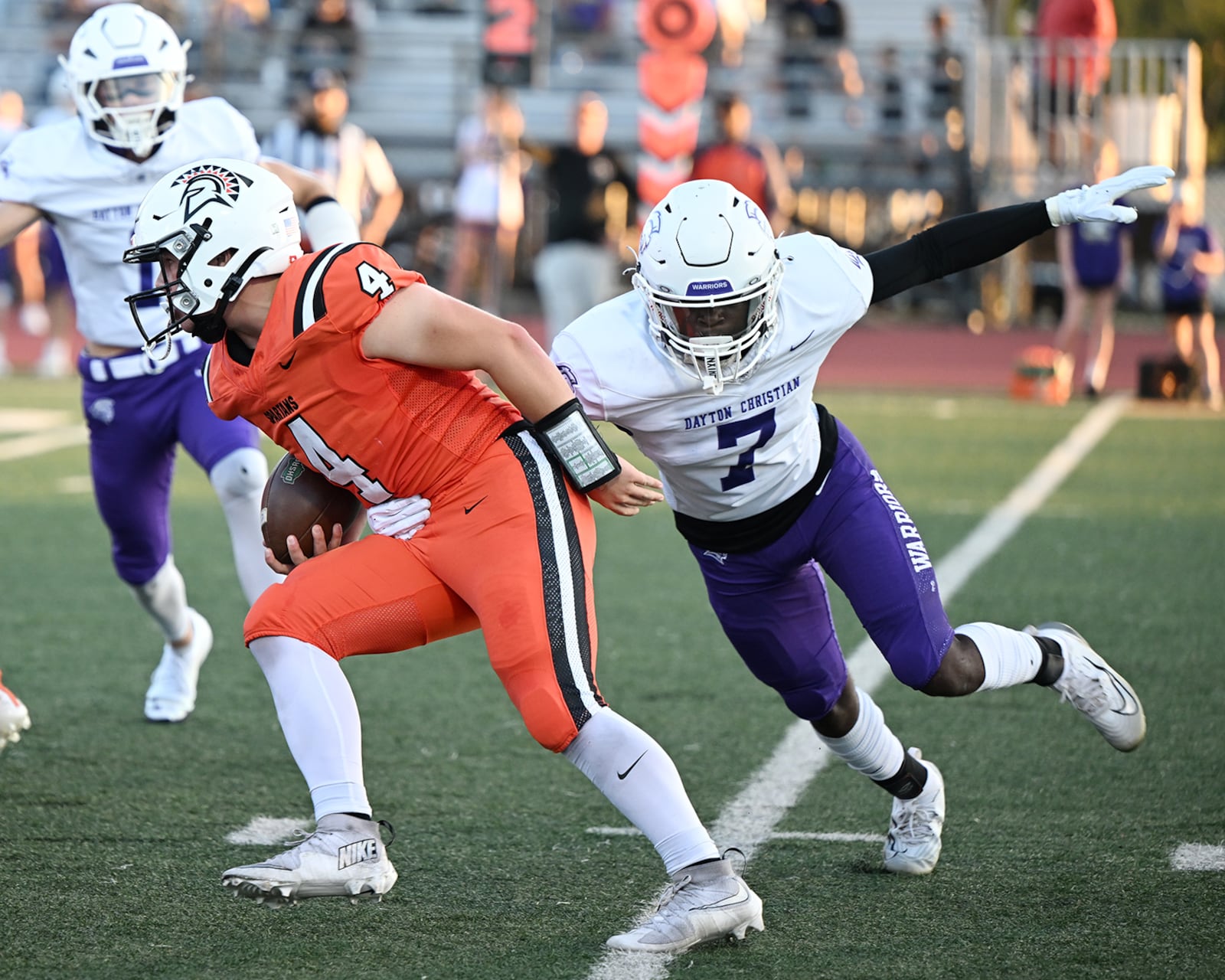 Dayton Christian senior Joe Jenkins reaches for Waynesville High School sophomore Gregory Marlow during their game on Friday, Sept. 26 at Spartan Stadium. The Spartans won 52-35. NICK FALZERANO / CONTRIBUTED PHOTO