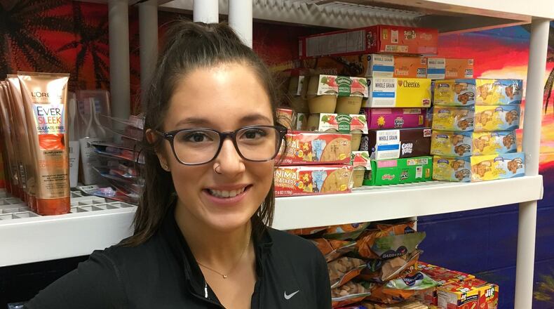 Madi Dunn, an 18-year-old Fairfield High School senior, started a food pantry inside the school for students who may not have enough to eat on the weekends. The pantry, which is in its second year of operation, serves dozens of high school students a week. MICHAEL D. PITMAN/STAFF