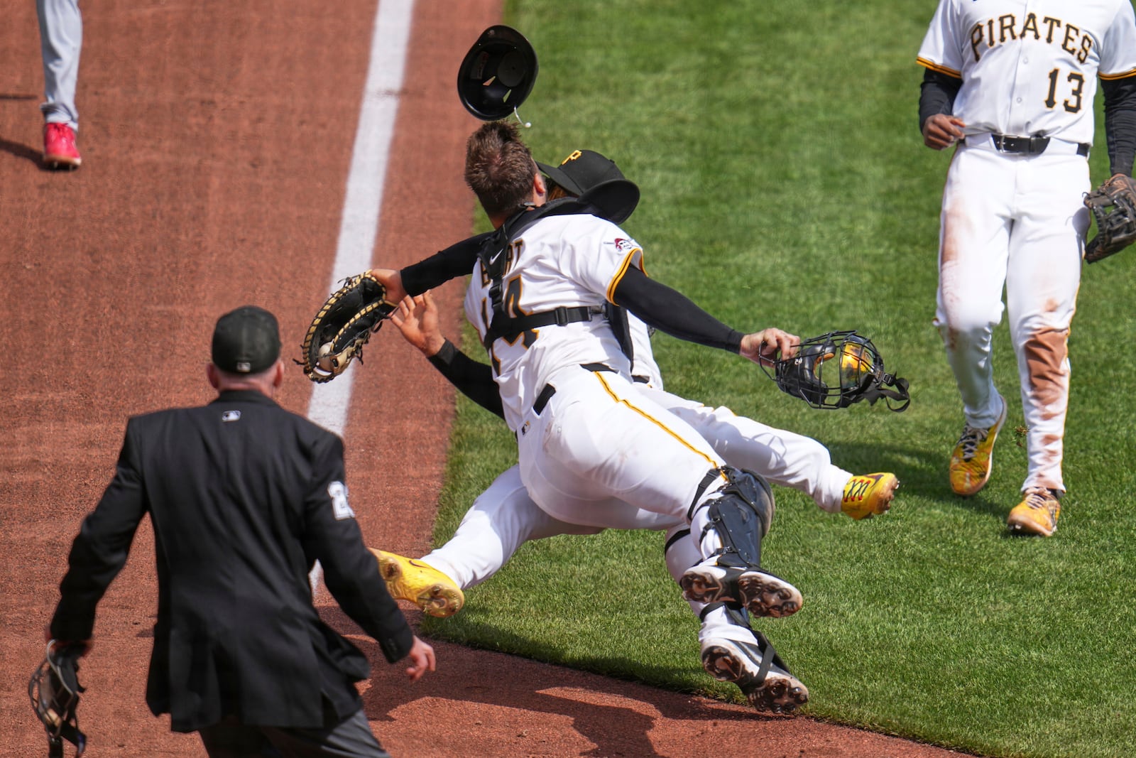 Pittsburgh Pirates first baseman Endy Rodríguez, rear, collides with catcher Joey Bart as they both attempt to field an infield pop-up by St. Louis Cardinals' Willson Contreras during the eighth inning of a baseball game in Pittsburgh, Wednesday, April 9, 2025. (AP Photo/Gene J. Puskar)