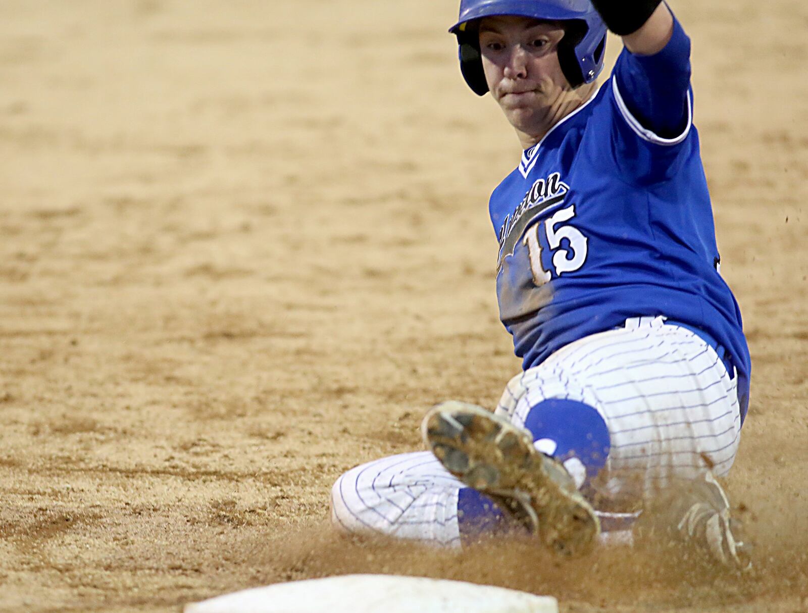 Hamilton’s Zach Bell slides safely into third base during Saturday night’s game against Badin at Alumni Field in Hamilton. CONTRIBUTED PHOTO BY E.L. HUBBARD