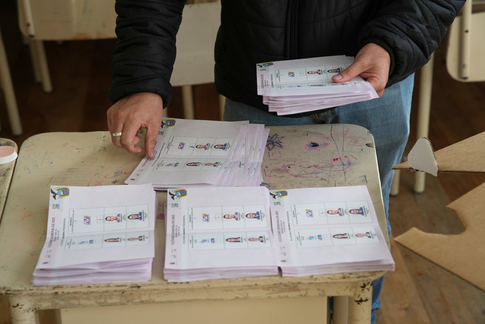Electoral officials count ballots after polls close in the presidential election runoff in Quito, Ecuador, Sunday, April 13, 2025. (AP Photo/Carlos Noriega)
