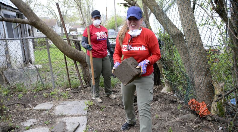 Nearly 500 Habitat for Humanities Rock the Block volunteers from within and outside Butler County made 21 exterior home repairs, painted 47 fire hydrants and worked to fill 11 32-cubic-foot Dumpsters on Saturday, April 13, 2019, in the Five Points area of the township. MICHAEL D. PITMAN/STAFF