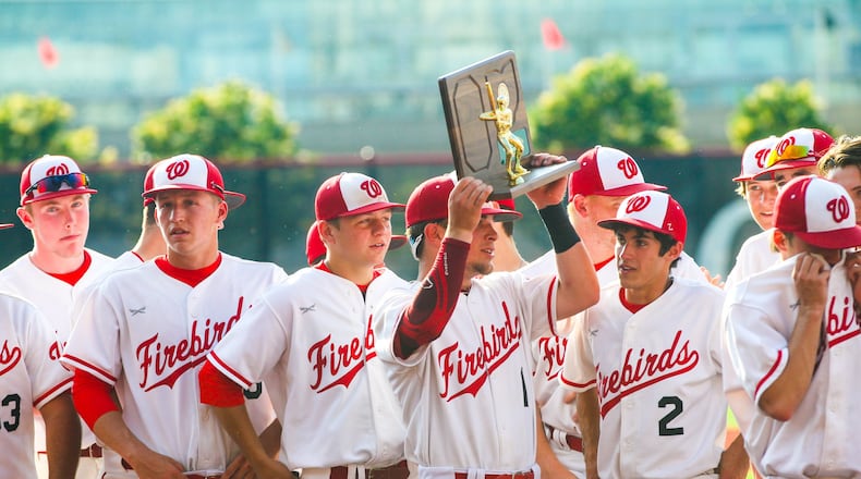 Lakota West’s Brennen Martin (1) holds up the Division I regional championship trophy Friday after the Firebirds defeated St. Xavier 2-1 at the University of Cincinnati’s Marge Schott Stadium. GREG LYNCH/STAFF