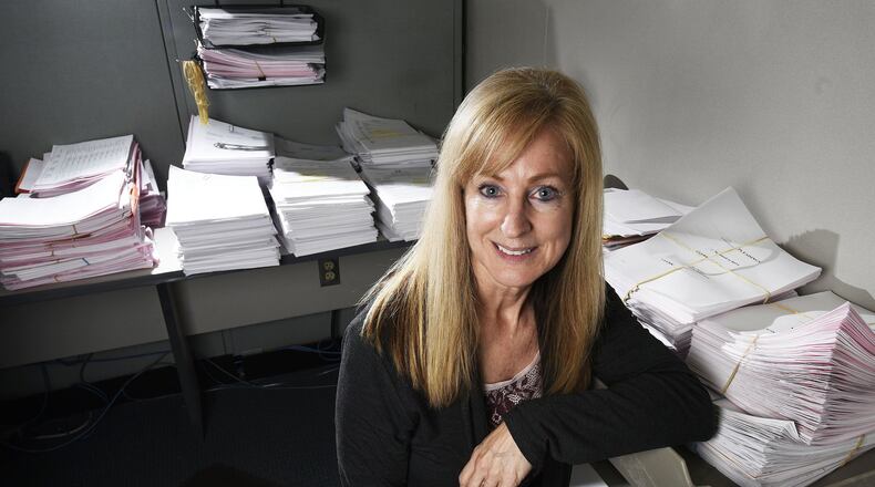 Teri Lenhoff, chief deputy clerk at Butler County Juvenile Courts office, kneels by stacks of incoming complaints, motions and filings from the Child Support Enforcement Agency. The juvenile courts have requested additional clerks to help with the paperwork as part of the 2017 county budget requests. A number of department heads and office holders asked for new staff, but that will be a tough call to make especially since the commissioners have a $5 million gap in the $97 million to fill. NICK GRAHAM/STAFF