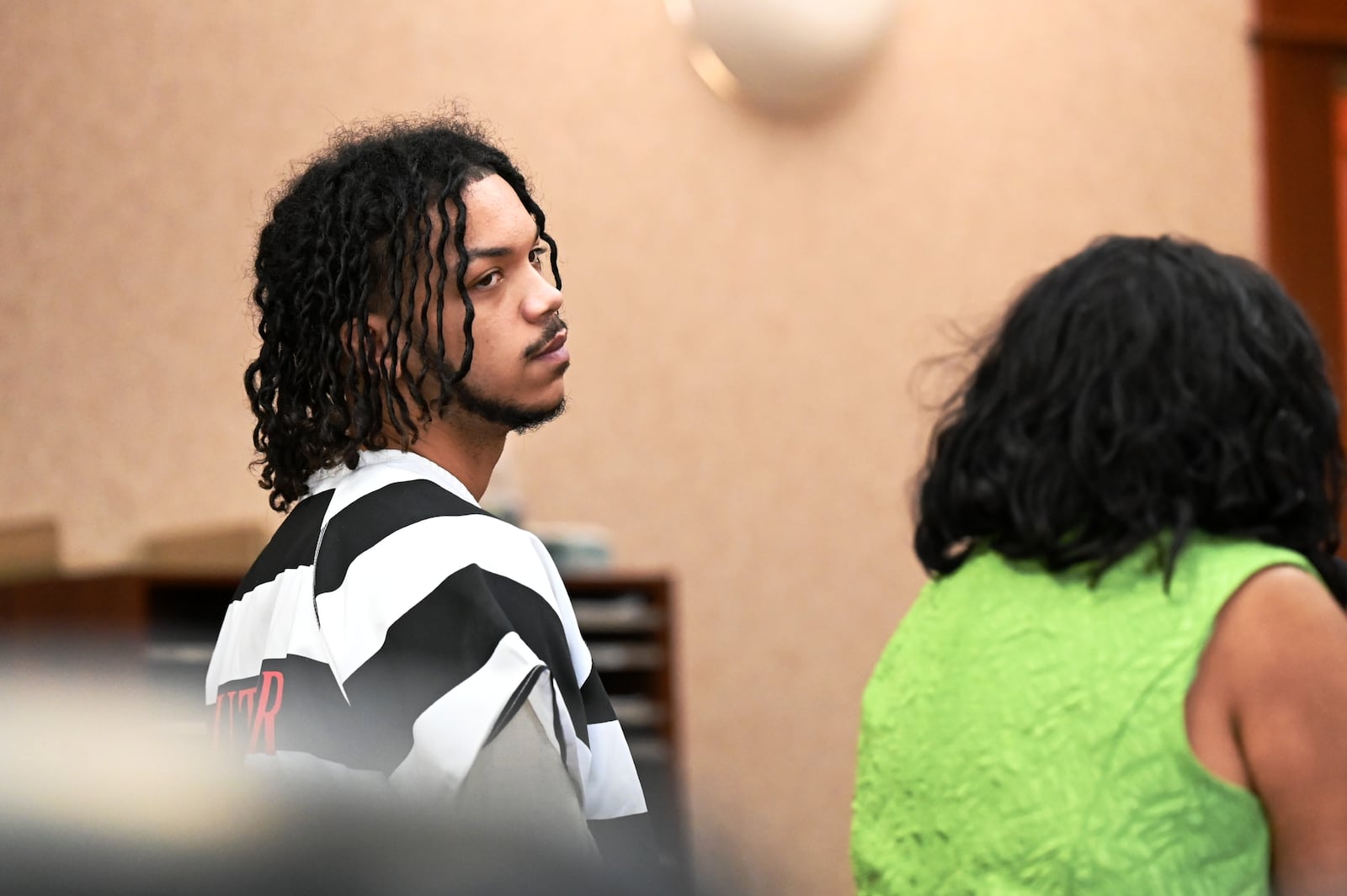 Dominick Grubb, 18, of Hamilton, was indicted last month on attempting to hire a person to kill a woman allegedly involved in another case he's involved with, an aggravated robbery from November 2024. Pictured is Grubb with his attorney, Arica Underwood, who he told Butler County Common Pleas Judge Jennifer McElfresh, he no longer wants her services and plans to retain a new attorney. MICHAEL D. PITMAN/STAFF