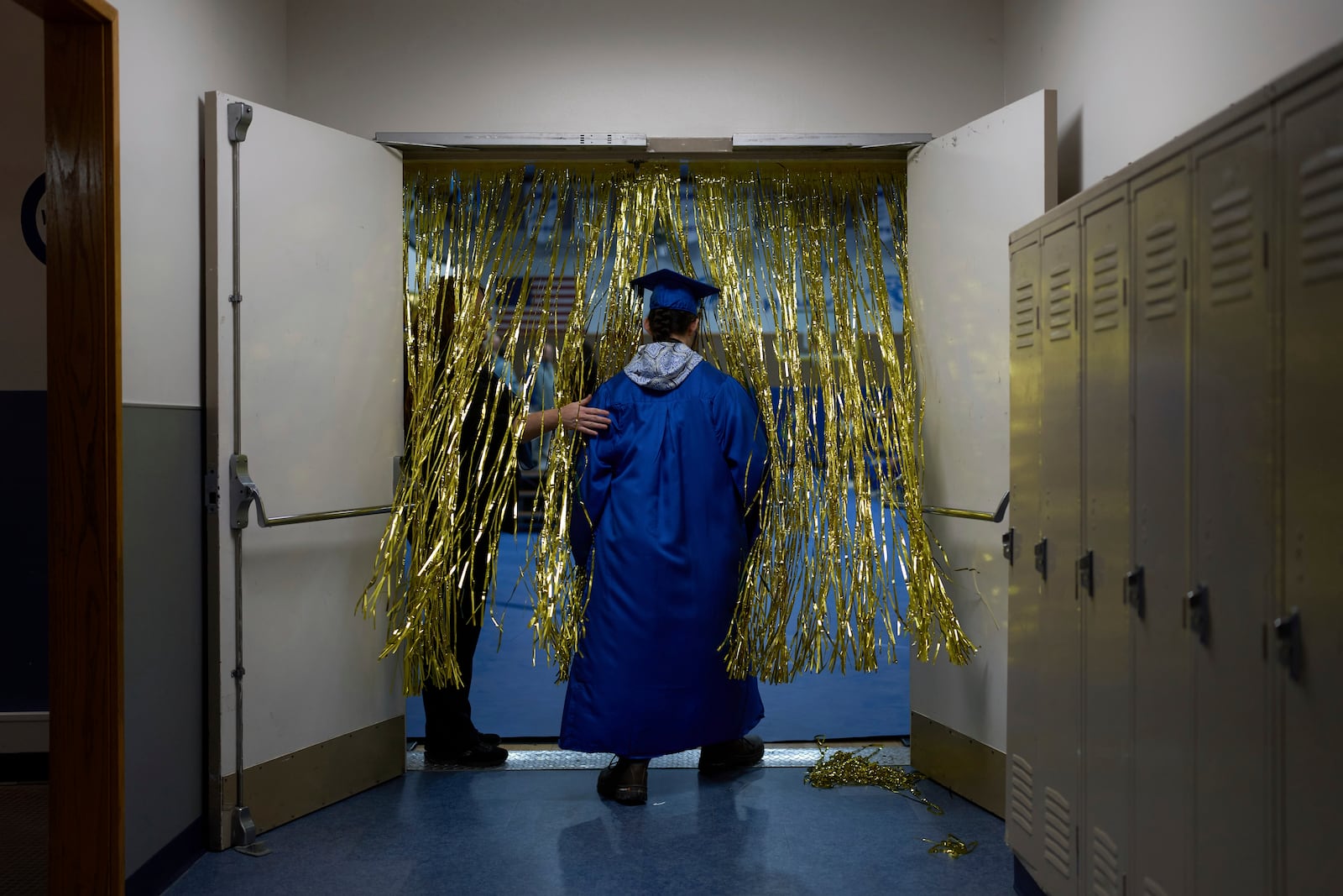 A student from the Galena Interior Learning Academy enters a gym during a graduation ceremony for the school Wednesday, May 21, 2025, in Galena, Alaska. (AP Photo/John Locher)