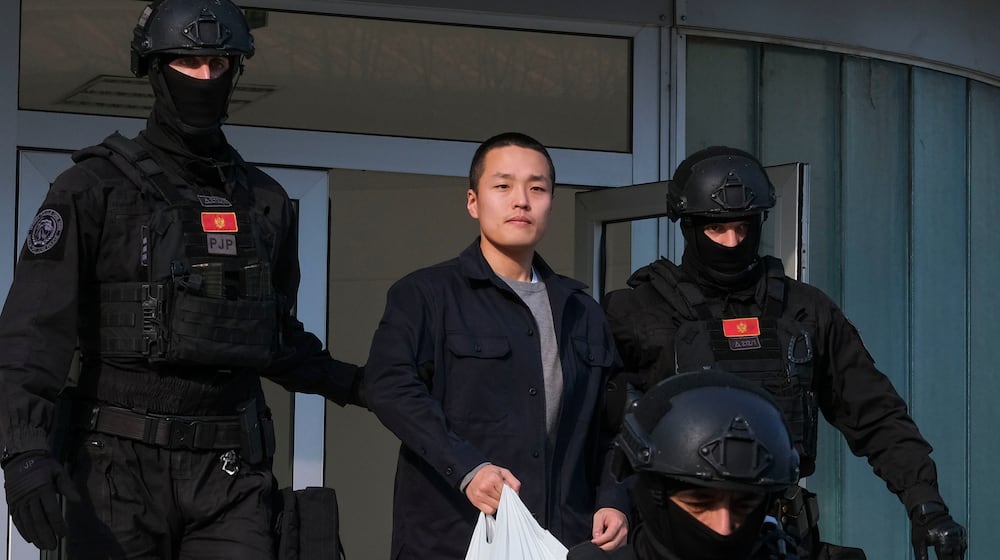 FILE - Montenegrin police officers escort South Korean citizen, Terraform Labs founder Do Kwon in Montenegro's capital Podgorica, March 23, 2024. (AP Photo/Risto Bozovic, File)