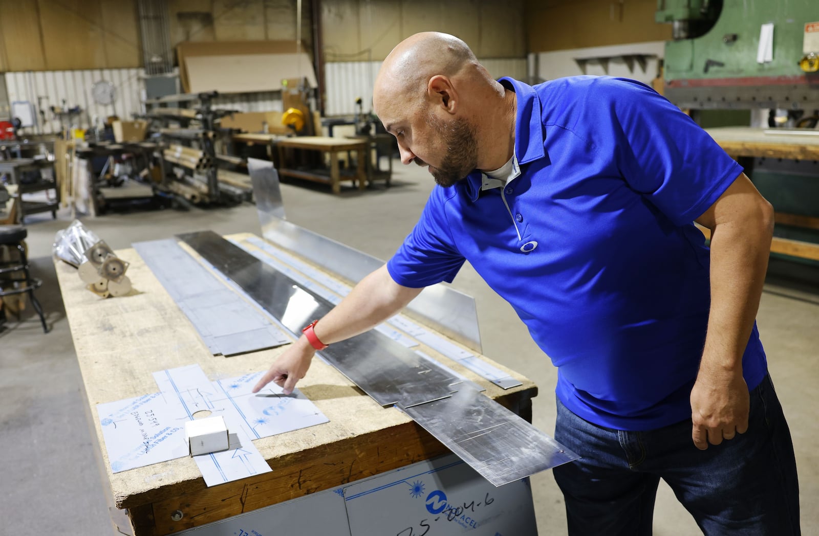 Co-owner Nick Bauer shows a job in production at DBS Stainless Steel Fabricators in Hamilton. The 40-year-old business specializes in cutom stainless steel products for the restaurant industry. NICK GRAHAM/STAFF