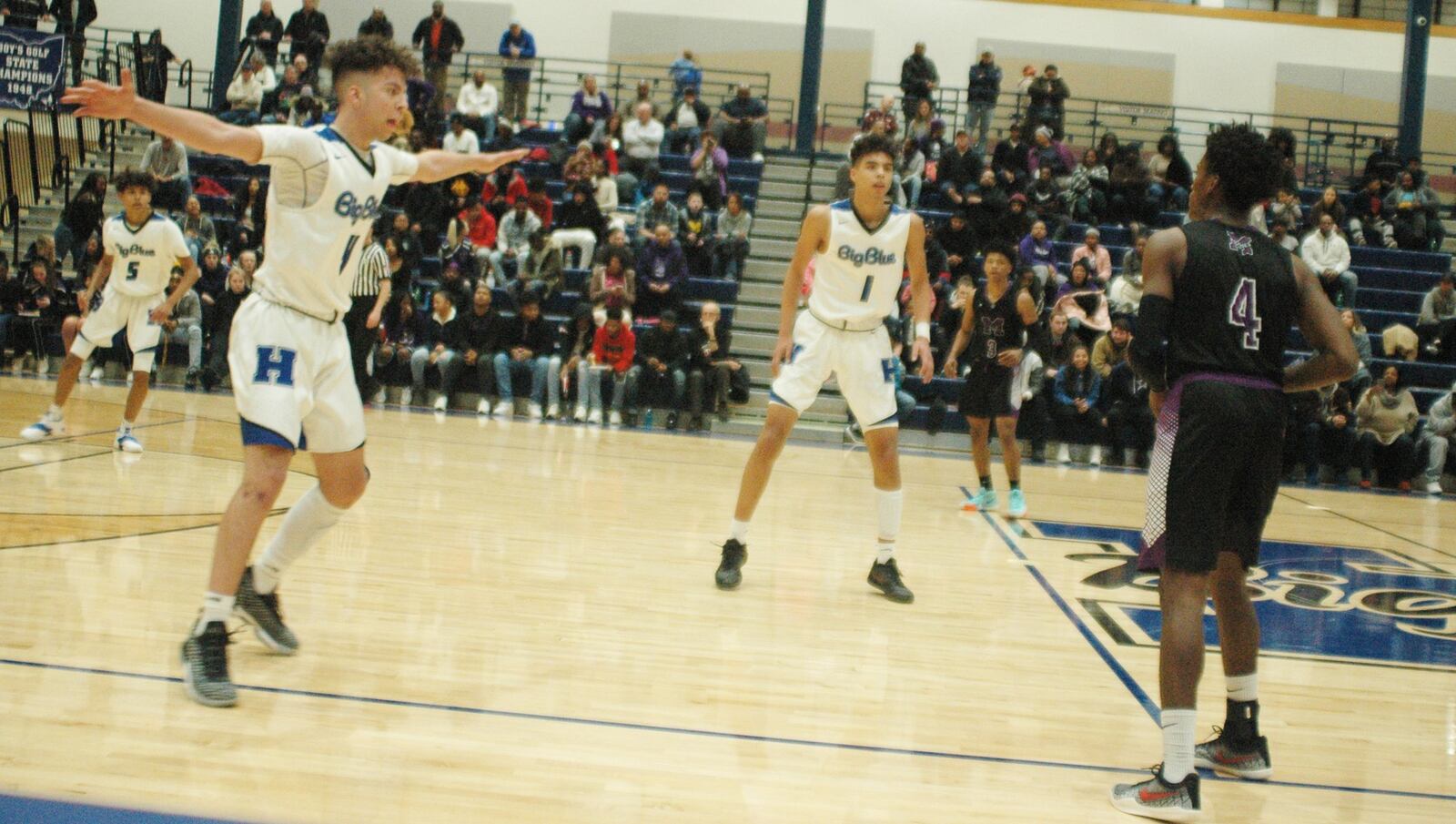 Hamilton’s Jaylen Robinson (left) and Trey Robinson (1) apply defensive pressure to Middletown’s Aaron Jones (4) on Tuesday night at the Hamilton Athletic Center. HHS rallied for a 48-47 victory. RICK CASSANO/STAFF
