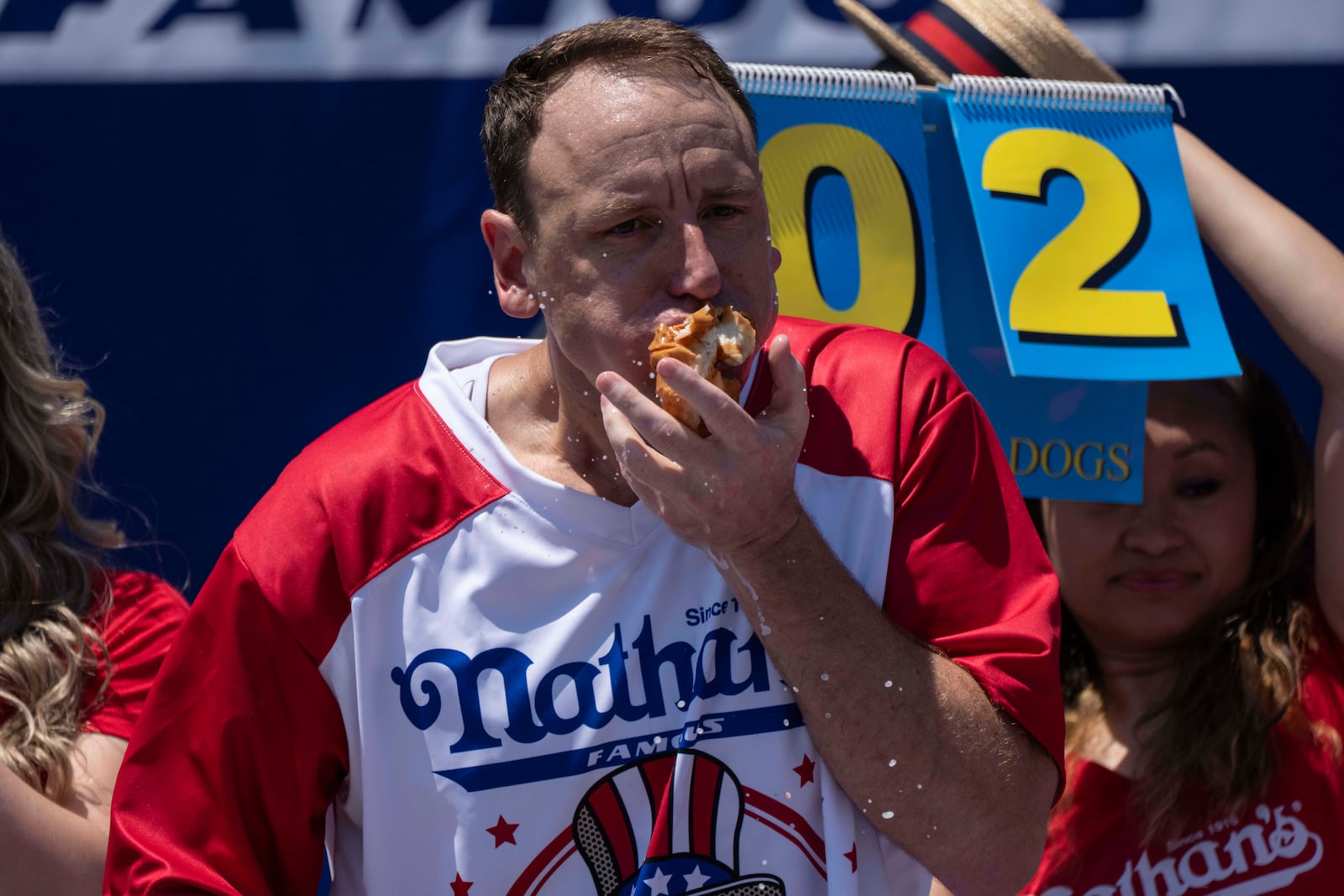 Competitive eater Joey Chestnut eats hot dogs during the 2025 Nathan's Famous Fourth of July hot dog eating contest in the Coney Island section of the Brooklyn borough of New York, Thursday, July 4, 2025. (AP Photo/Yuki Iwamura)