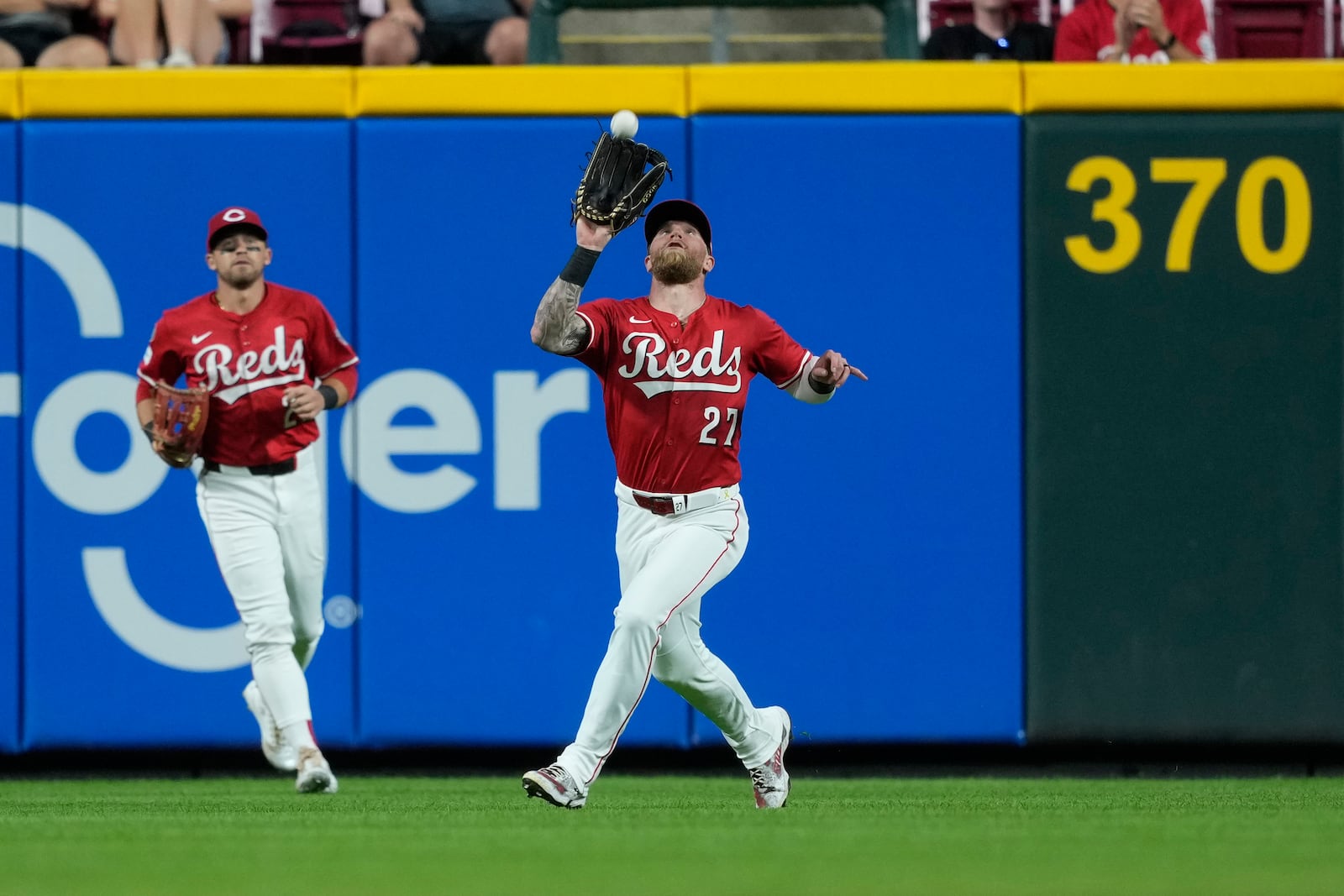 Cincinnati Reds right fielder Jake Fraley catches a fly ball hit by Minnesota Twins' Matt Wallner the sixth inning of a baseball game, Wednesday, June 18, 2025, in Cincinnati. Reds center fielder TJ Friedl is left. (AP Photo/Carolyn Kaster)