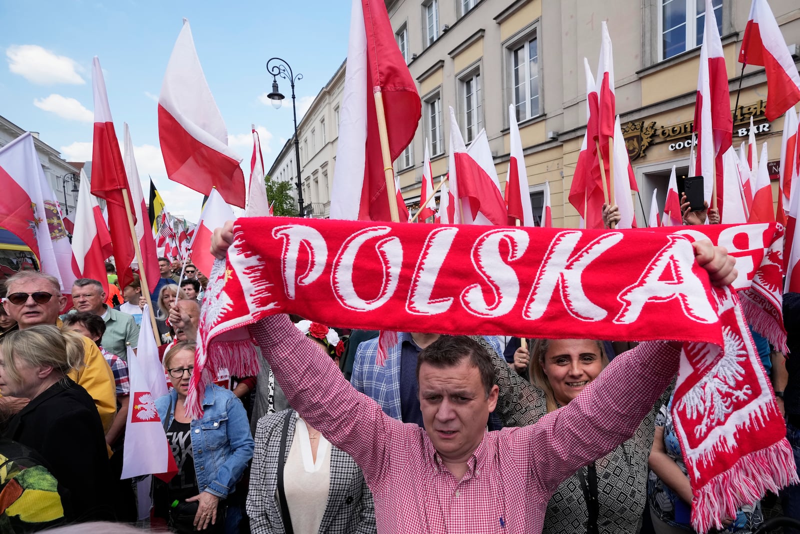Supporters of conservative presidential candidate Karol Nawrocki take part in a march one week ahead of a decisive election in Warsaw Poland, Sunday, May 25, 2025. (AP Photo/Czarek Sokolowski)