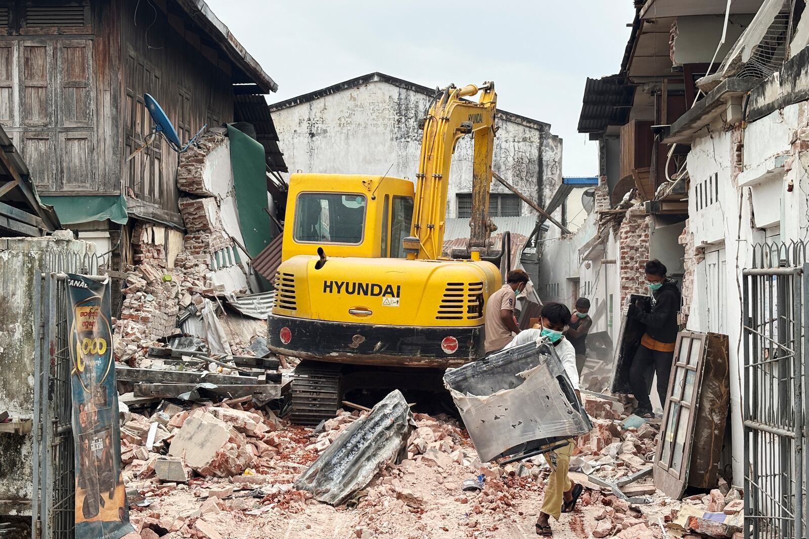 People clean debris from damaged buildings in the aftermath of an earthquake on March 28, in Naypyitaw, Myanmar, Monday, April 7, 2025. (AP Photo)