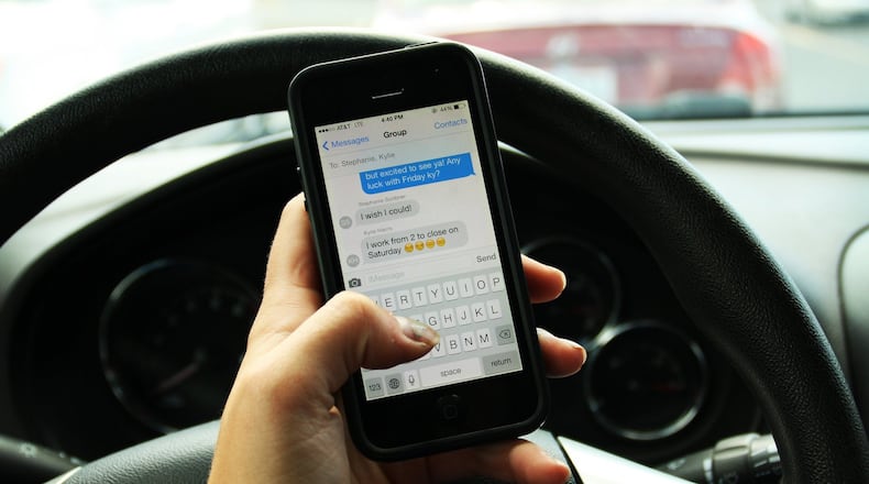 The Ohio House of Representatives approved a bill that would levy a $100 fine for committing a moving violation while driving distracted by texting or other activities. PHOTO ILLUSTRATION BY LAUREN OLSON