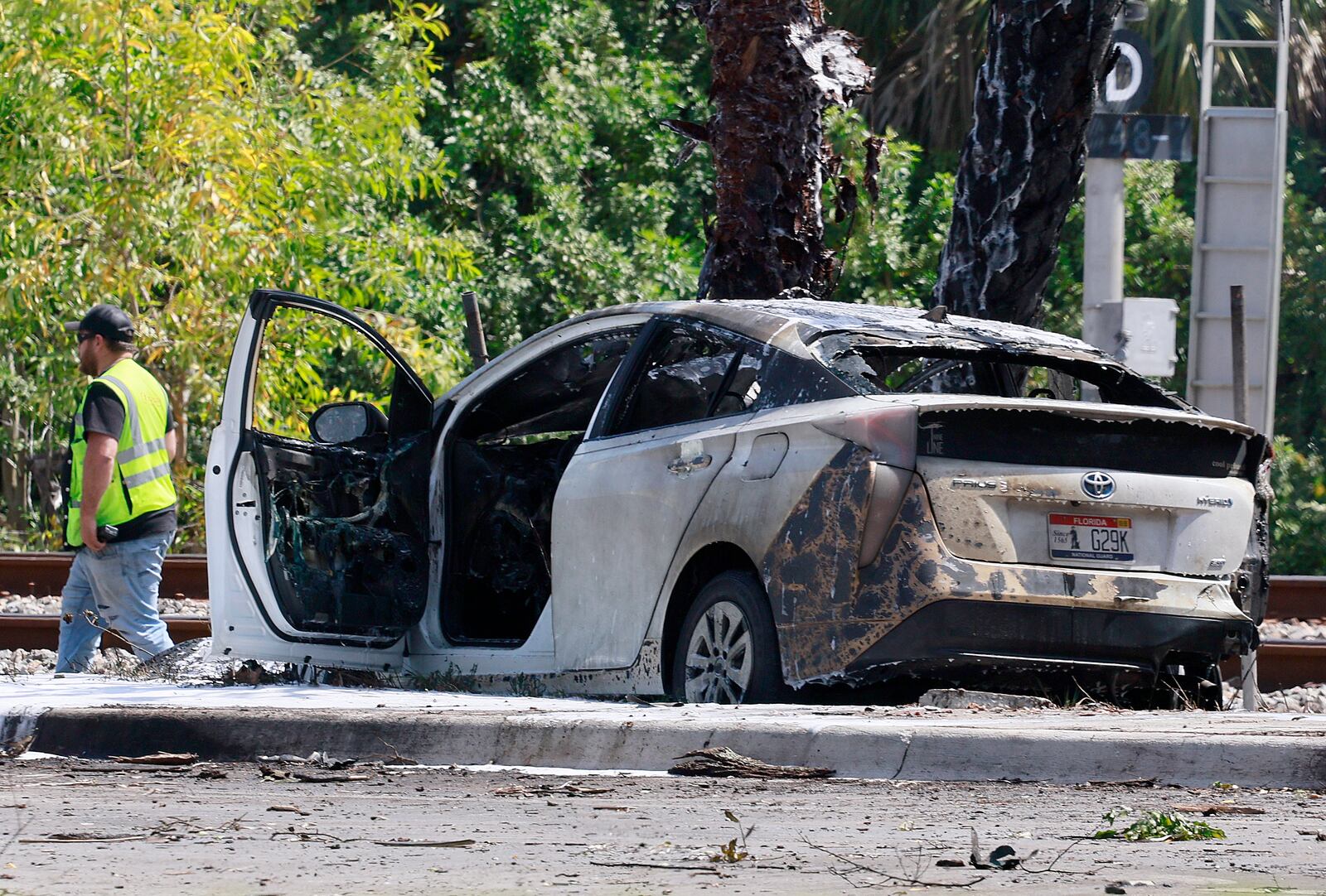 Emergency personnel respond to the area where a small plane crashed on the railroad tracks beneath the overpass near Interstate 95 in Boca Raton, Fla., on Friday, April 11, 2025. (Mike Stocker /South Florida Sun-Sentinel via AP)
