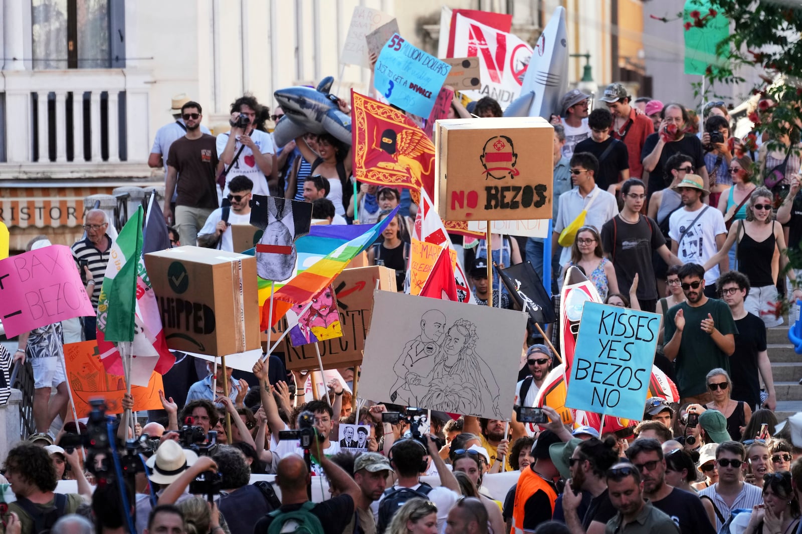 Activists stage a protest in Venice, Italy, Saturday, June 28, 2025, denouncing the three-day celebrations for the wedding between Jeff Bezos and his wife Lauren Sanchez Bezos that took place in Venice on Friday as a symbol of rising inequality and disregard for the city's residents. (AP Photo/Antonio Calanni)