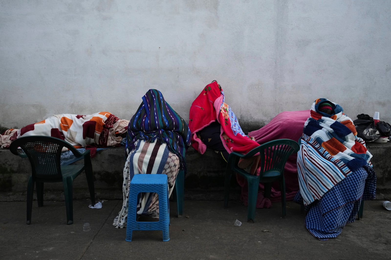 Neighbors remain outside their home in Palin, Guatemala, Wednesday, July 9, 2025, After a series of earthquakes with magnitudes ranging from 3.0 to 5.6, according to authorities. (AP Photo/Moises Castillo)