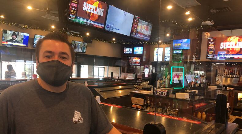 Bob MacKendrick, co-owner and general manager of Berd's Grill & Bar in Fairfield, is excited about customers watching NCAA Tournament games this year after the tourney was cancelled last year due to the coronavirus pandemic. RICK McCRABB/STAFF