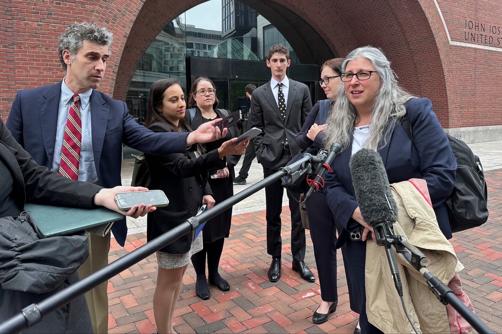 Lawyers for several individuals facing deportation speak to the media Wednesday, May 21, 2025, in Boston, after a federal judge ruled the White House violated a court order on deportations to third countries with a flight linked to the chaotic African nation of South Sudan. (AP Photo/Michael Casey)