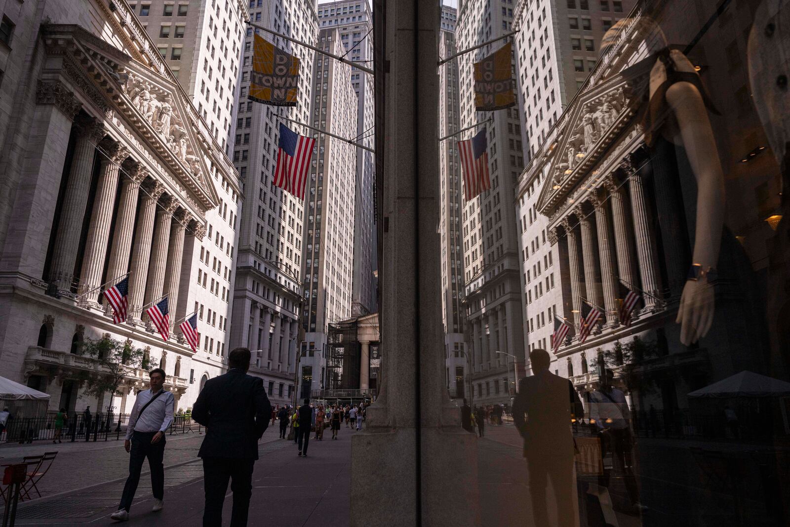 A reflection of a window shows the New York Stock Exchange on Monday, June 30, 2025, in New York. (AP Photo/Yuki Iwamura)