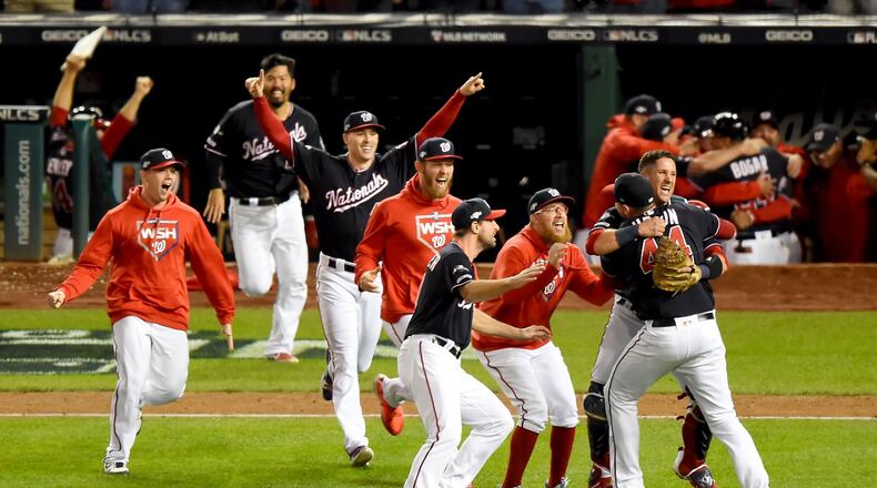 WASHINGTON, DC - OCTOBER 15: Daniel Hudson #44 of the Washington Nationals and Yan Gomes #10 celebrate with teammates after defeating the St. Louis Cardinals to win Game Four of the National League Championship Series at Nationals Park on October 15, 2019 in Washington, DC. (Photo by Will Newton/Getty Images)