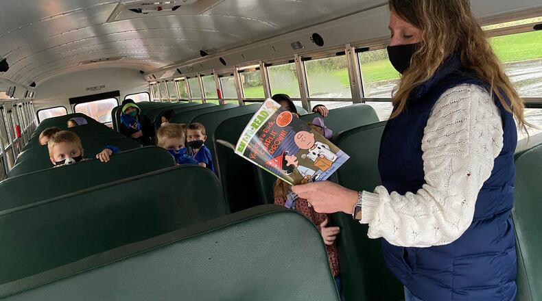 Springboro schools bus driver Karen Borgemenke takes the time to read to her students on the bus before the start of school. CONTRIBUTED