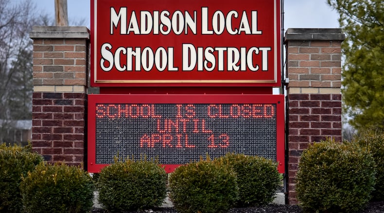 The sign at Madison Local School District displays school is closed until April 13 on it Tuesday, March 17, 2020. The Governor of Ohio ordered all schools to be closed for three weeks to help reduce the spread of coronavirus. NICK GRAHAM / STAFF