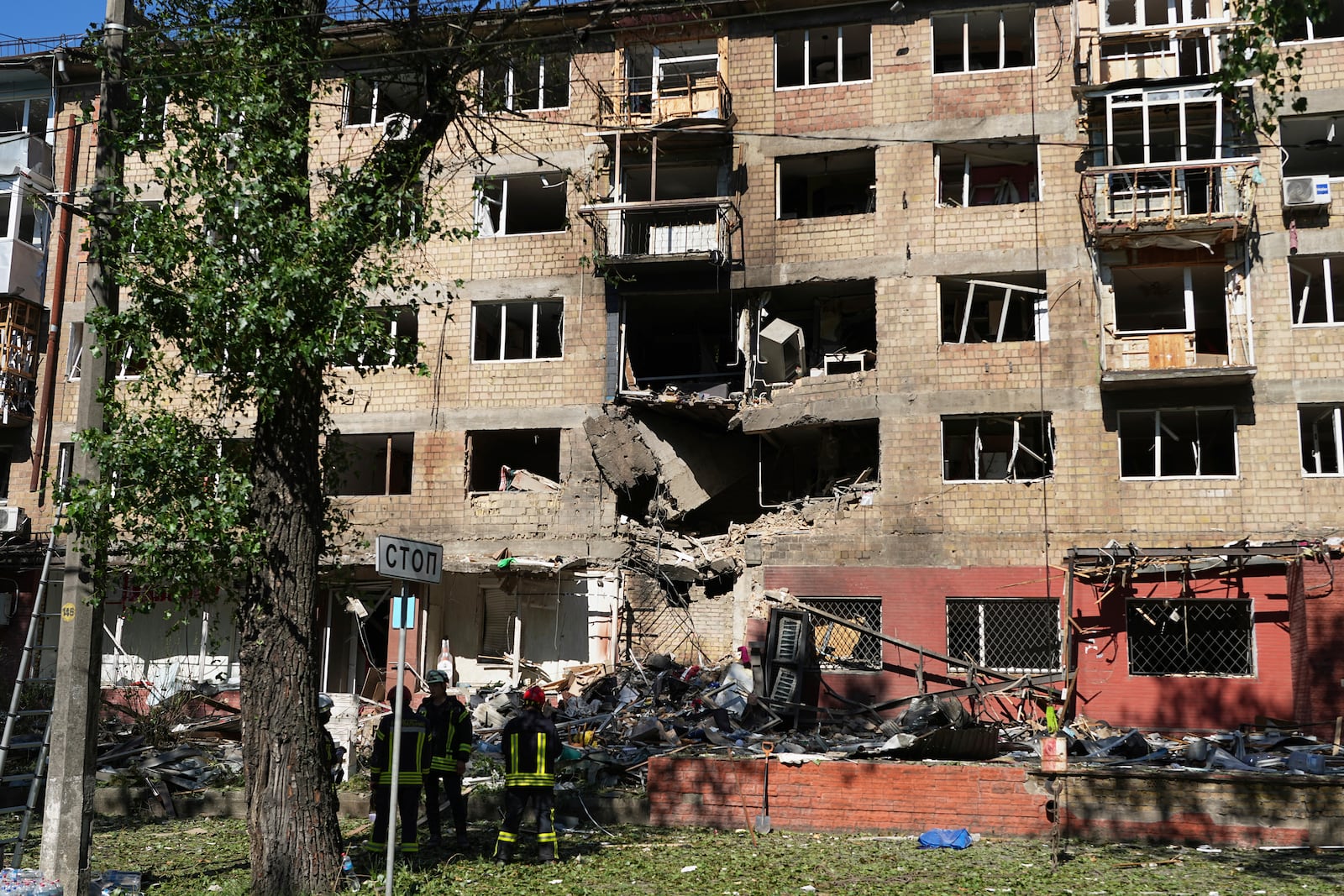 Firefighters work at a destroyed apartment building after a Russian drone and missile attacks in Kyiv, Ukraine, Friday, July 4, 2025. (AP Photo/Efrem Lukatsky)