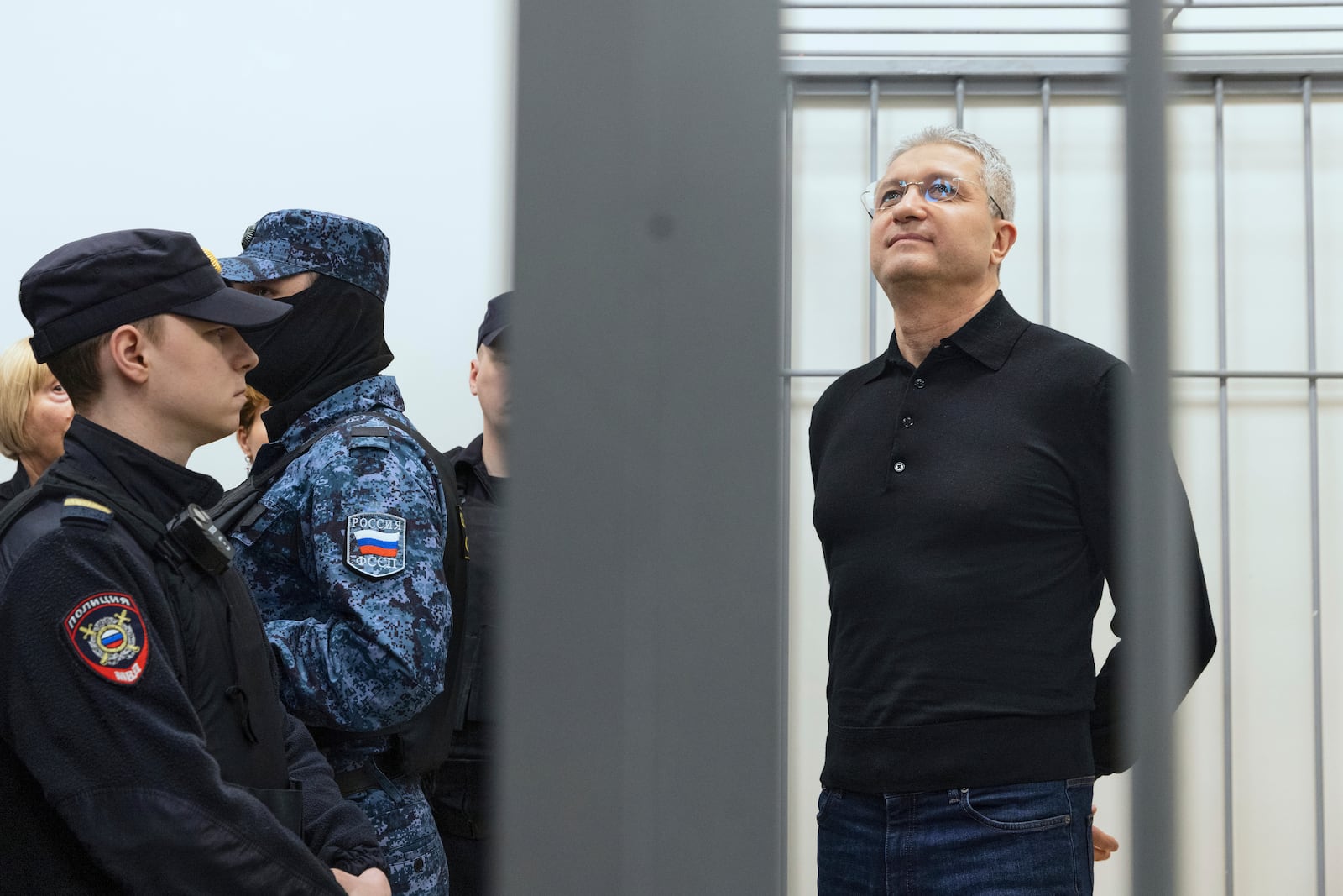 Timur Ivanov, Russia's former deputy defense minister facing corruption charges, right, stands in the defendant's cage before a hearing, in the Moscow City Court in Moscow, Russia, Tuesday, July 1, 2025. (AP Photo)