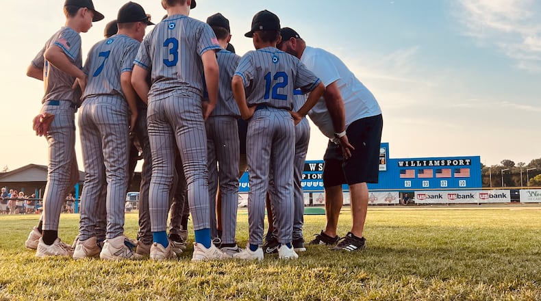 West Side players and coaches gather in a huddle before taking the field against Galion in the Ohio Little League state tournament on Tuesday at West Side Little League. Chris Vogt/CONTRIBUTED
