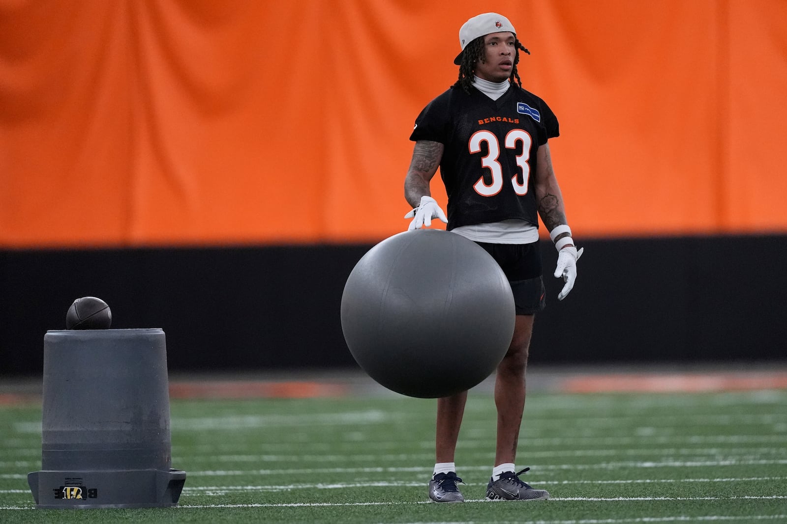 Cincinnati Bengals safety Daijahn Anthony bounces an exercise ball during NFL football practice, Tuesday, May 20, 2025, in Cincinnati. (AP Photo/Carolyn Kaster)
