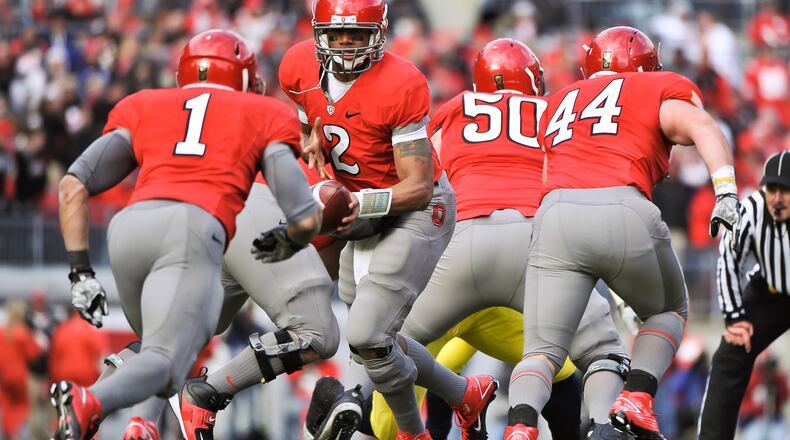 COLUMBUS, OH - NOVEMBER 27: Quarterback Terrelle Pryor #2 of the Ohio State Buckeyes hands off against the Michigan Wolverines at Ohio Stadium on November 27, 2010 in Columbus, Ohio. (Photo by Jamie Sabau/Getty Images)