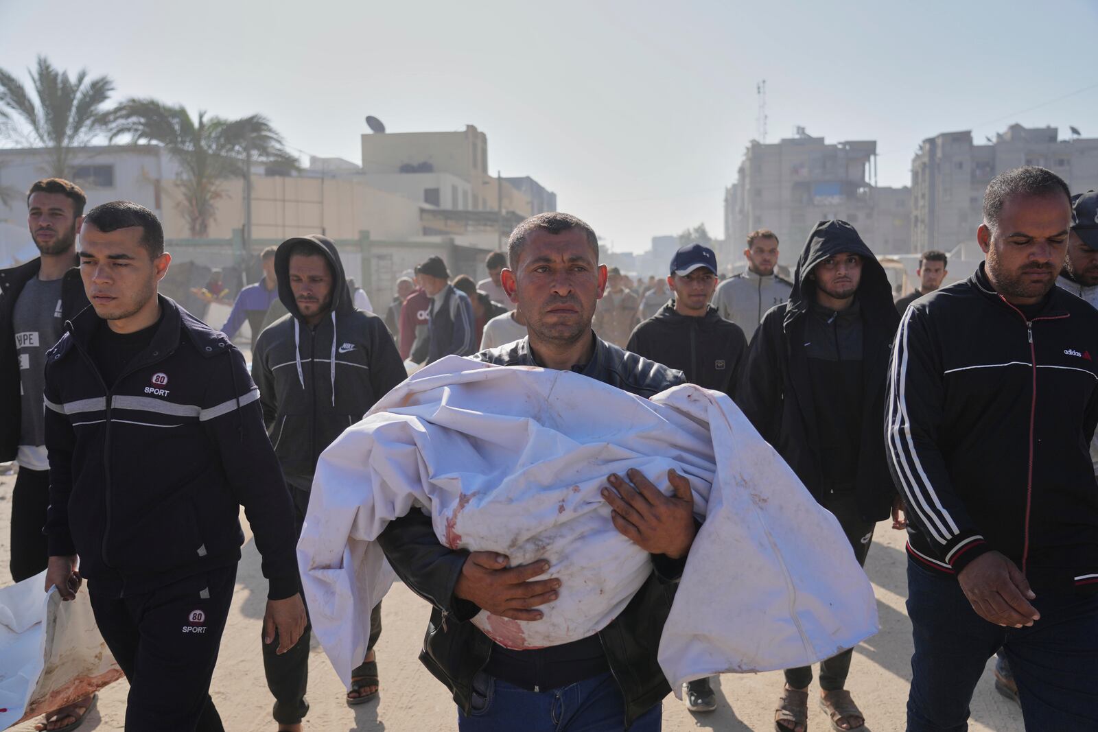 Mohammad Al-Qadi carrying body of his nephew who was killed in an Israeli army airstrike, during his funeral in Khan Younis, southern Gaza Strip, Saturday, April 19, 2025. (AP Photo/Abdel Kareem Hana)