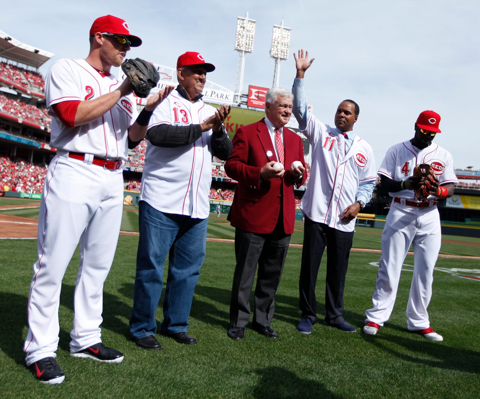 Reds shortstop Zack Cozart, former Red Dave Concepcion, owner Bob Castellini, former Red Barry Larkin and second baseman Brandon Phillips are introduced before a game against the Cardinals on Opening Day at Great American Ball Park on Monday, March 31, 2014, in Cincinnati. David Jablonski/Staff