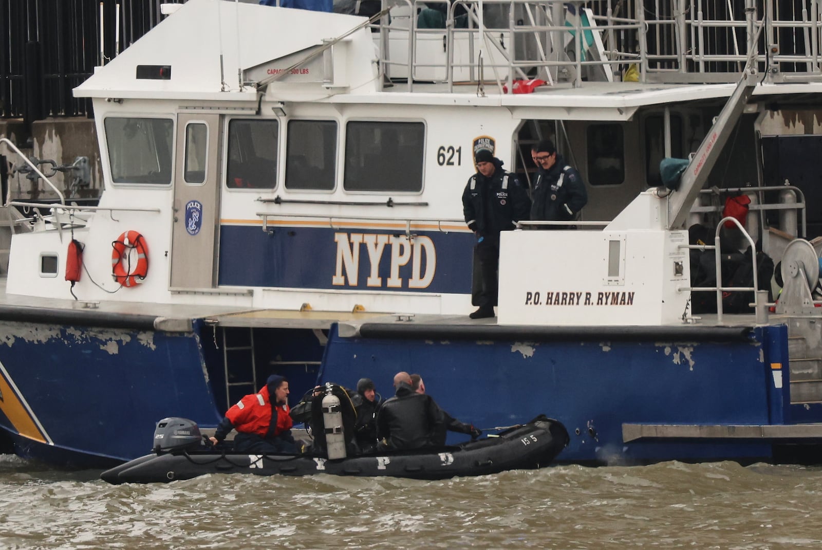A New York Police Department scuba team prepares to dive, Friday, April 11, 2025, where a sightseeing helicopter crashed a day earlier into the Hudson River in Jersey City, N.J. (AP Photo/Yuki Iwamura)