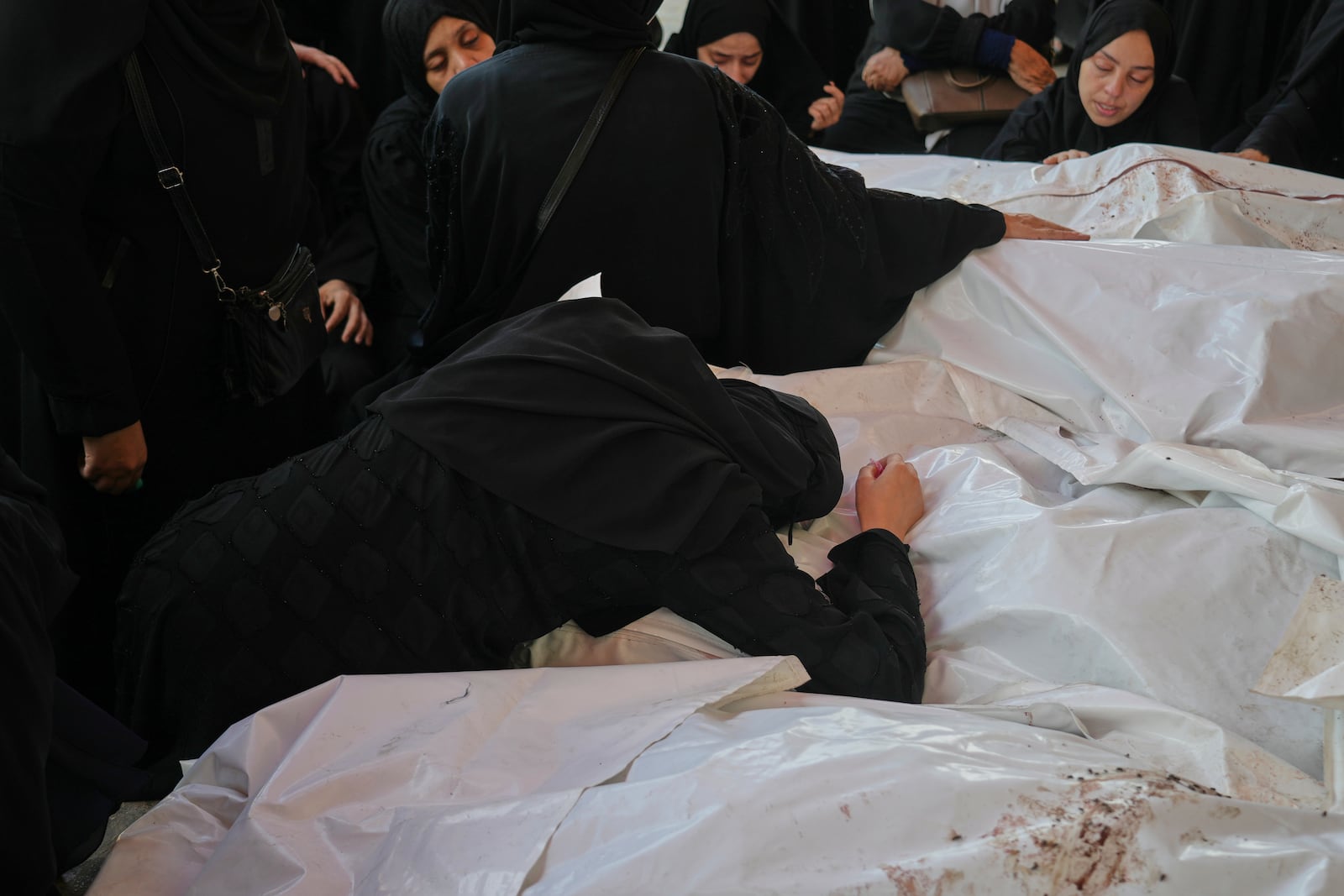 Mourners attend the funeral of their relatives who were killed in an Israeli bombardment, in Deir al-Balah, Gaza Strip, Saturday, July 12, 2025. (AP Photo/Abdel Kareem Hana)