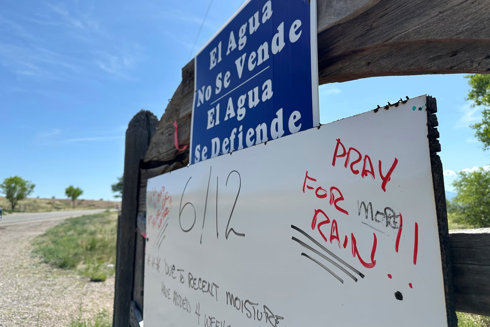 A sign posted along a traditional irrigation canal known as an acequia requests that passersby pray for rain as the monsoon gets under way near Española, New Mexico, on June 13, 2025. (AP Photo/Susan Montoya Bryan)